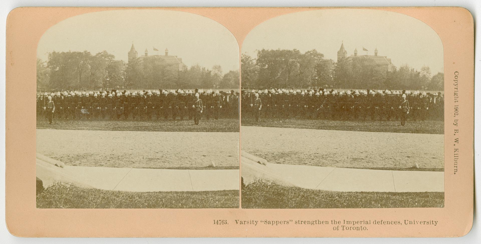 Pictures show a line of soldiers in a field with a large building in the far background