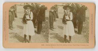 Pictures show a little girl in a white dress holding a medium sized dog.