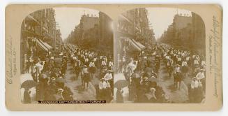 Pictures show men in white jackets and straw hats on horseback parading on a city street