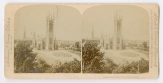 Pictures show a gothic church with a circular flower bed n front of it.