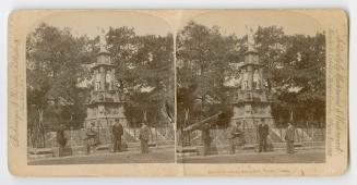 Pictures show four men standing in from of a large memorial with steps leading up to it.