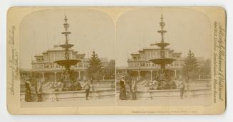 Pictures show people standing around elaborate gardens and a fountain with a Victorian building…