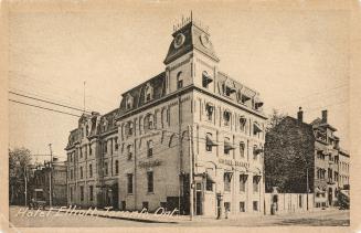 Black and white picture of a four story hotel building taken from a corner angle.