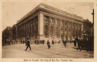 Black and white picture of a street corner showing huge public building in a classical style of…