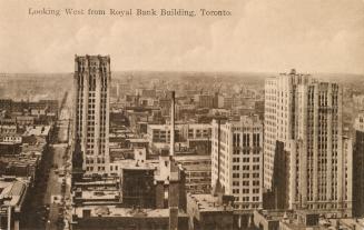 Black and white aerial shot of a large city with skyscrapers.
