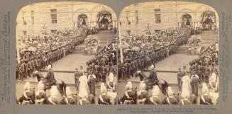 Pictures show soldiers and crowds standing along side a walkway and stairs leading to a doorway…