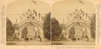 Pictures show a huge archway in front of the Ontario Legislative building with horse drawn vehi…