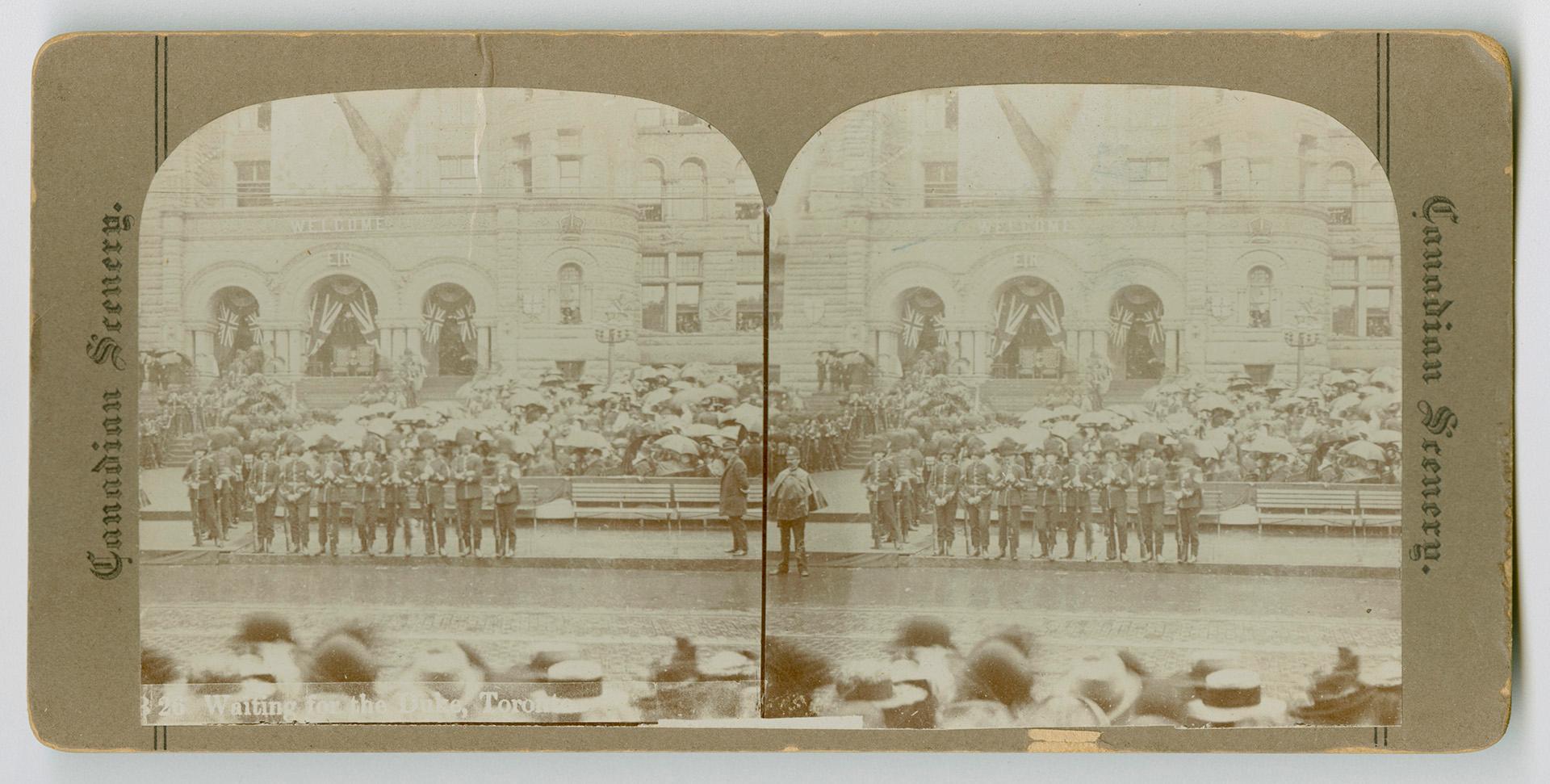 Pictures show soldiers and crows with umbrella lined up outside of the front door of a festoone…