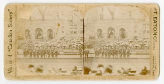 Pictures show soldiers standing in front of the archways of a Richardsonian Romanesque building…