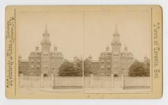 Pictures show a four story building with a central tower and steeple surrounded by a picket fen…