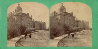 Pictures show a man and boy standing in front of a huge stone hospital building with a central …