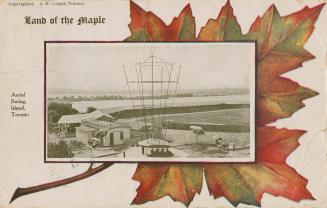 Picture of an aerial swing ride at an amusement park set in a maple leaf frame. 