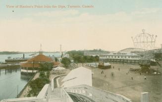 Picture of rides at an amusement park with lake in the background. 