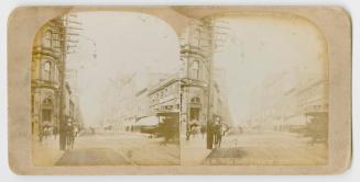 Pictures show a busy city street with horse drawn vehicles.