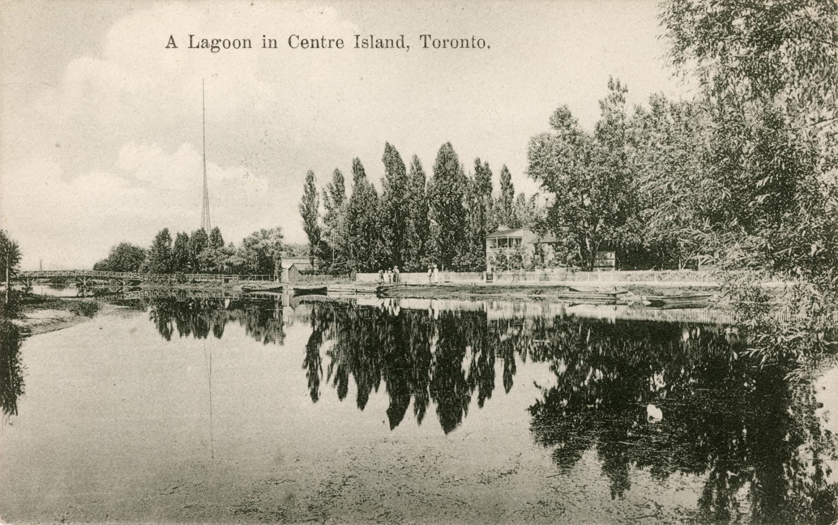 Picture of lagoon lined with trees that are reflected in the water. 