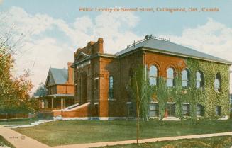 Picture of a street corner with ivy covered public library and house to the left of it with lar…