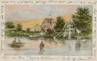 Fountains in a lagoon with boaters and a cottage and trees in the background. 