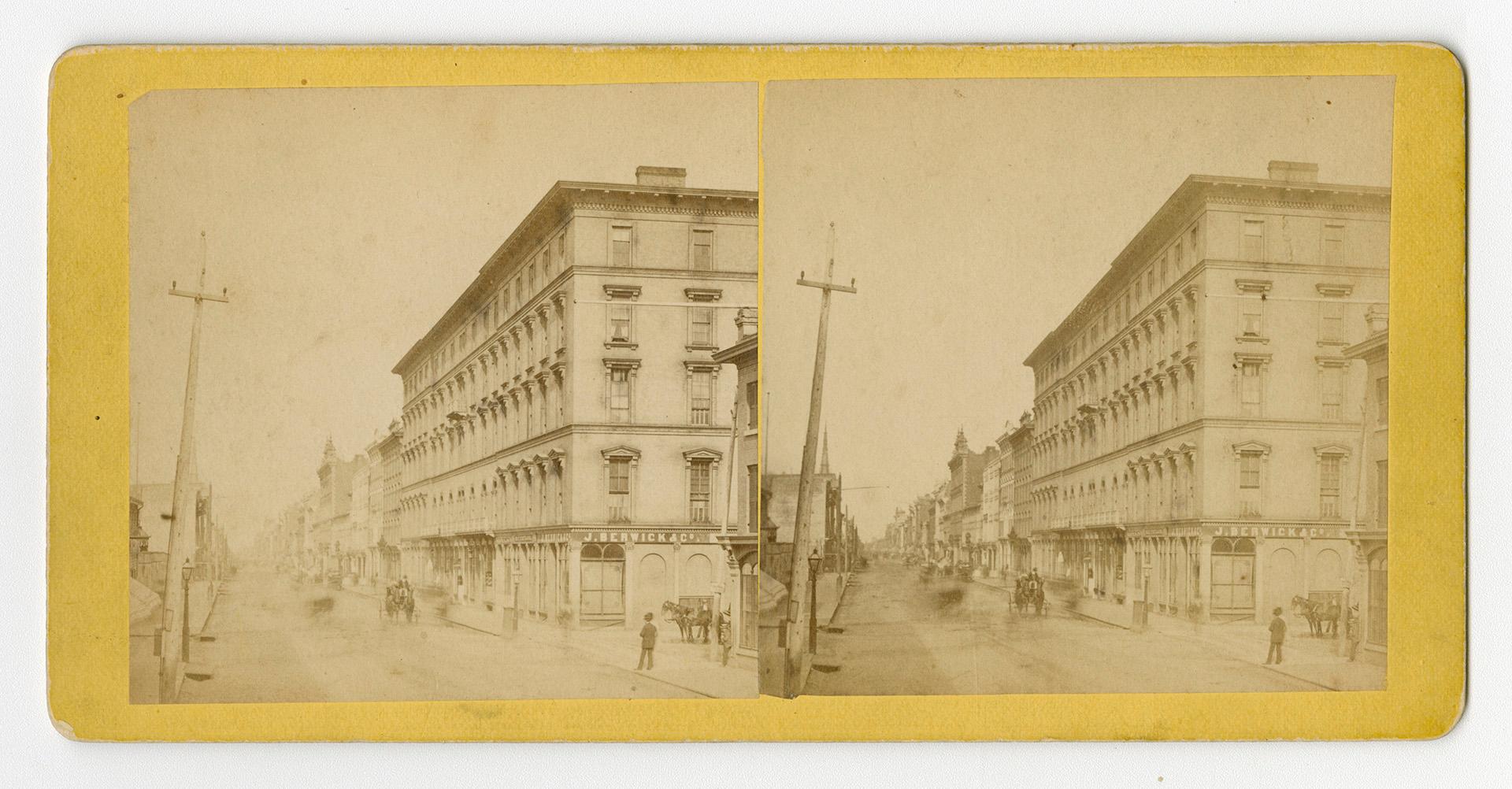 Pictures show a city street with large buildings on either side of it.