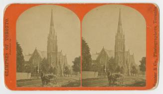 Pictures show a horse and cart on a road in front of a gothic revival style church with a tall …