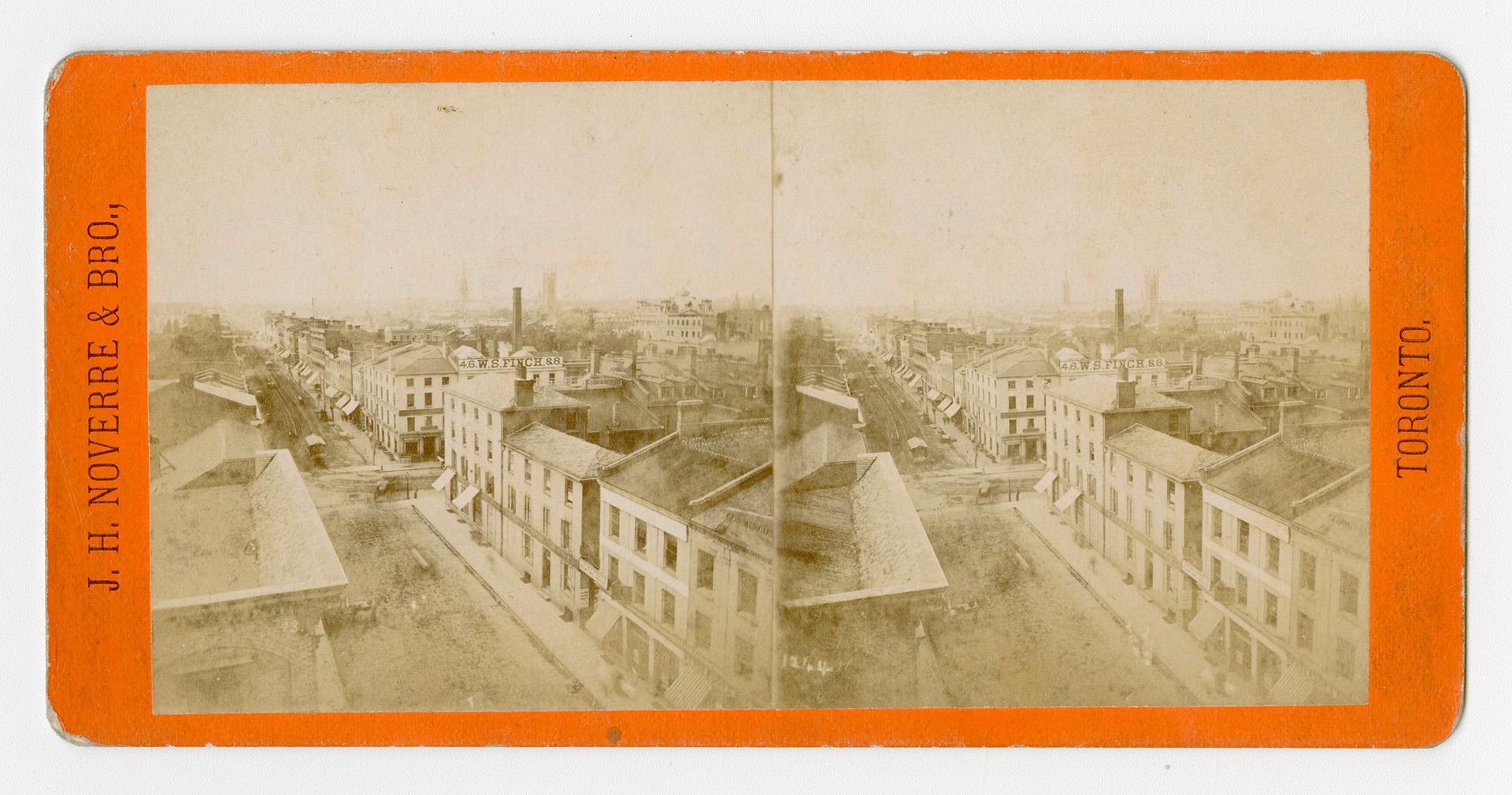 Pictures show a wide street with houses and large building on either side of it.