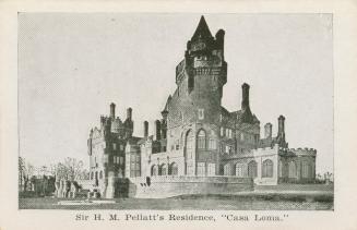 A photograph of a large castle-style mansion in a Gothic Revival style, with many turrets and a…