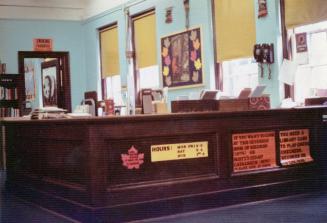 Picture of a large wooden reference desk. 