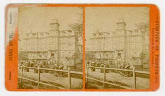 Pictures show a five story public building with a central tower.