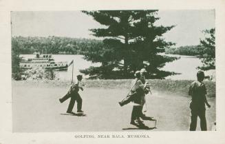 Black and white picture of four men on a golf green in front of a lake with a steam ship passin…