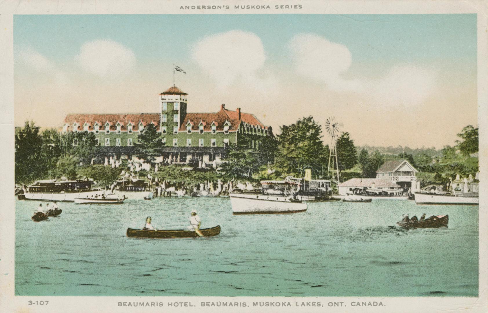 Many boats on a lake in front of a huge, luxury hotel.