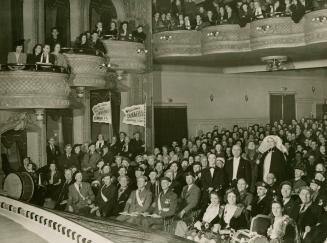 Black and white photograph of the audience of a Dumbells' performance in the Grand Theatre of C…