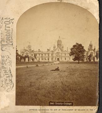 Half a stereoscope slide showing a man sitting on the lawn in front of a large building in the …