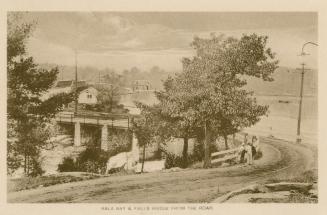 Sepia toned photograph of a highway running over a bridge over a body of water.