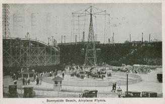 Rides at an amusement park including a roller coaster. 