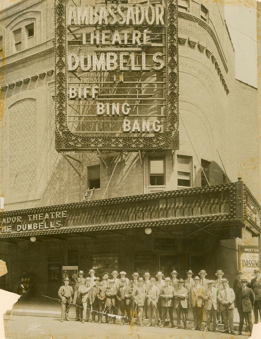 Black and white photograph of the cast of the Dumbells in Biff! Bing! Bang! posing in front of …