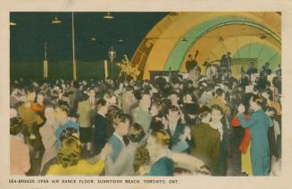 Picture of couples dancing to a band at an outdoor dance hall. 