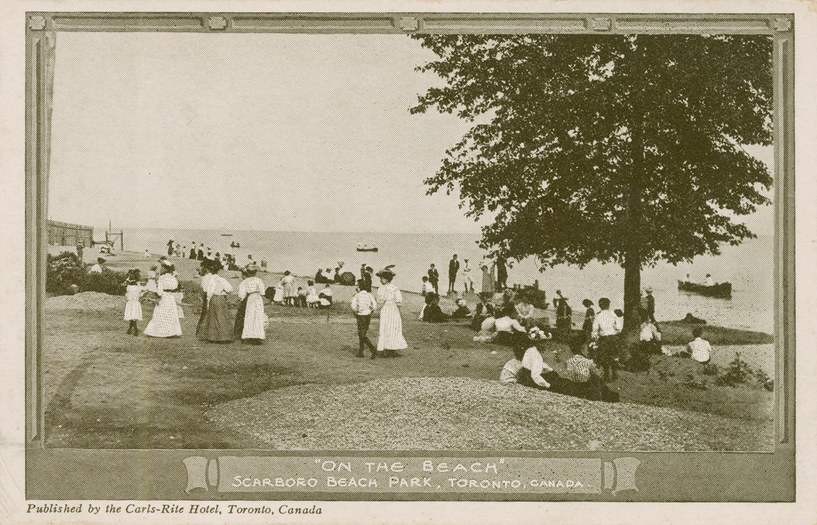 People standing and setting on a beach.