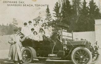 Black and white photograph of a car full of children in an amusement park.