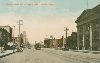 A streetcar running along a city street with two and three story buildings on both sides