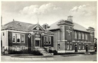 Picture of one storey library and large town hall on the right. 