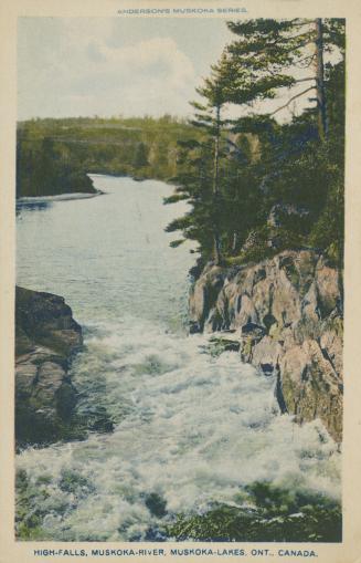 A river with rushing rapids cuts through rocky terrain.