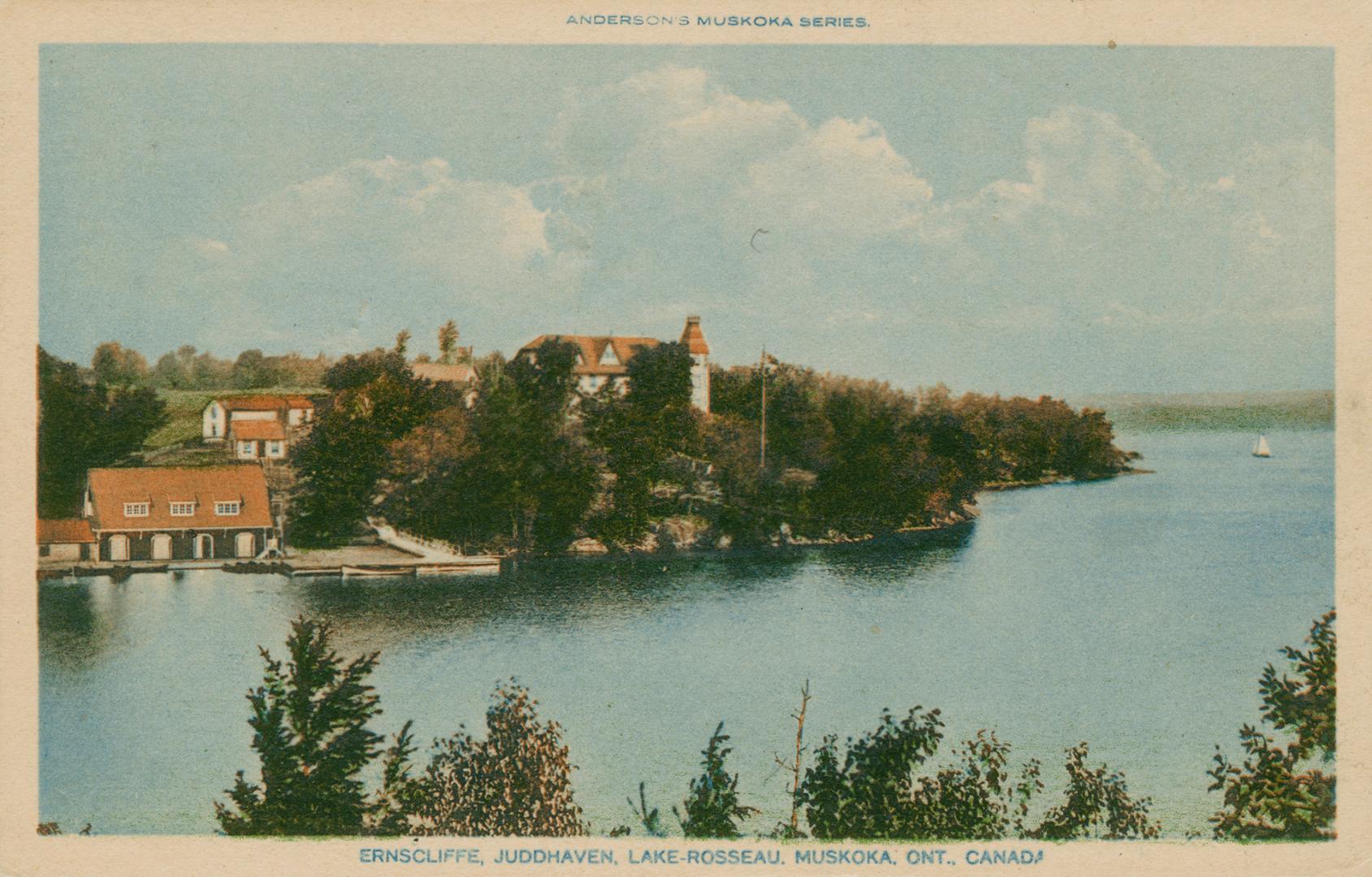 Resort buildings on the edge of a lake in the wilderness.