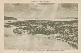 Bird's eye view of lake and an island with large hotel buildings. 