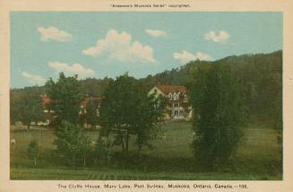 A three story hotel building complex deep within the woods.