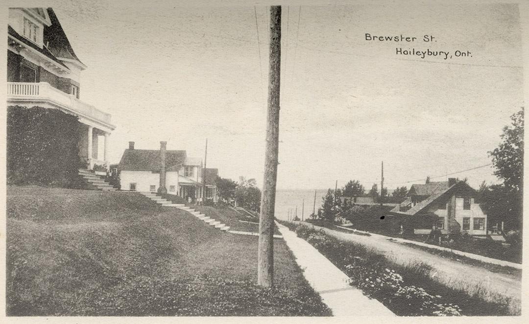 Photograph of houses lining a street in a small town.