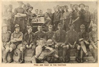 Sepia toned picture of a group of airmen grouped around an upright piano.