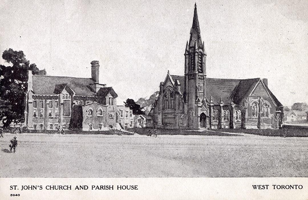 Picture from a distance of large church building with a tall steeple and parish hall.