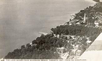 Black and white aerial shot of an amusement park on the edge of a lake. B & W.