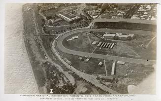 Aerial shot of a track by a lake. B & W.