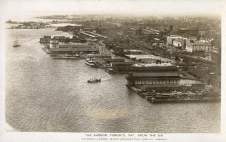 Aerial shot of a large city harbor beside a lake. B & W.