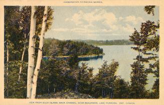 View of a lake from a rocky wilderness.